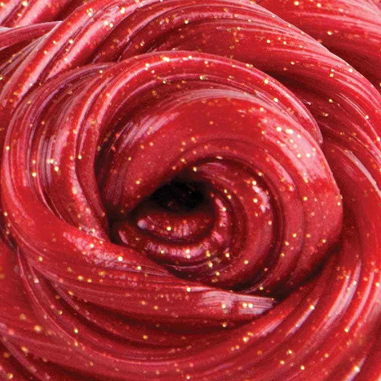 Close up detail of red putty with gold glitter.